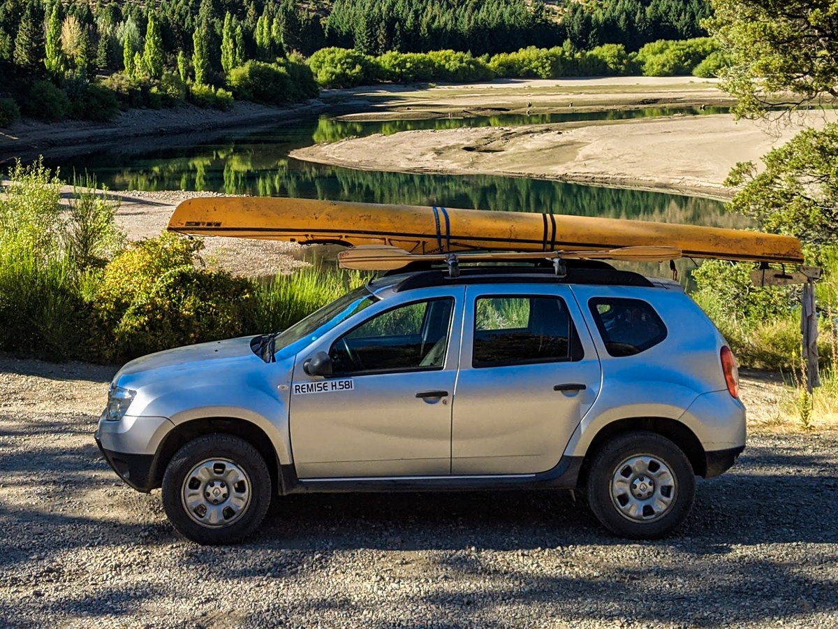 A kayak strapped to the roof of a car